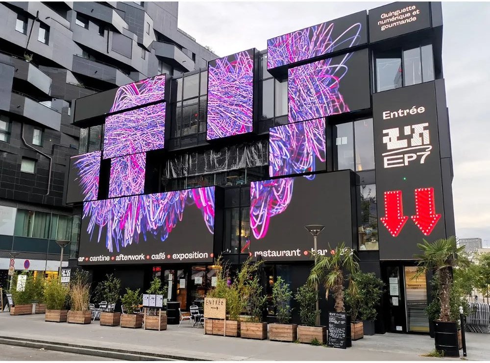 Large-format outdoor LED display integrated into a building facade as an installation reference
